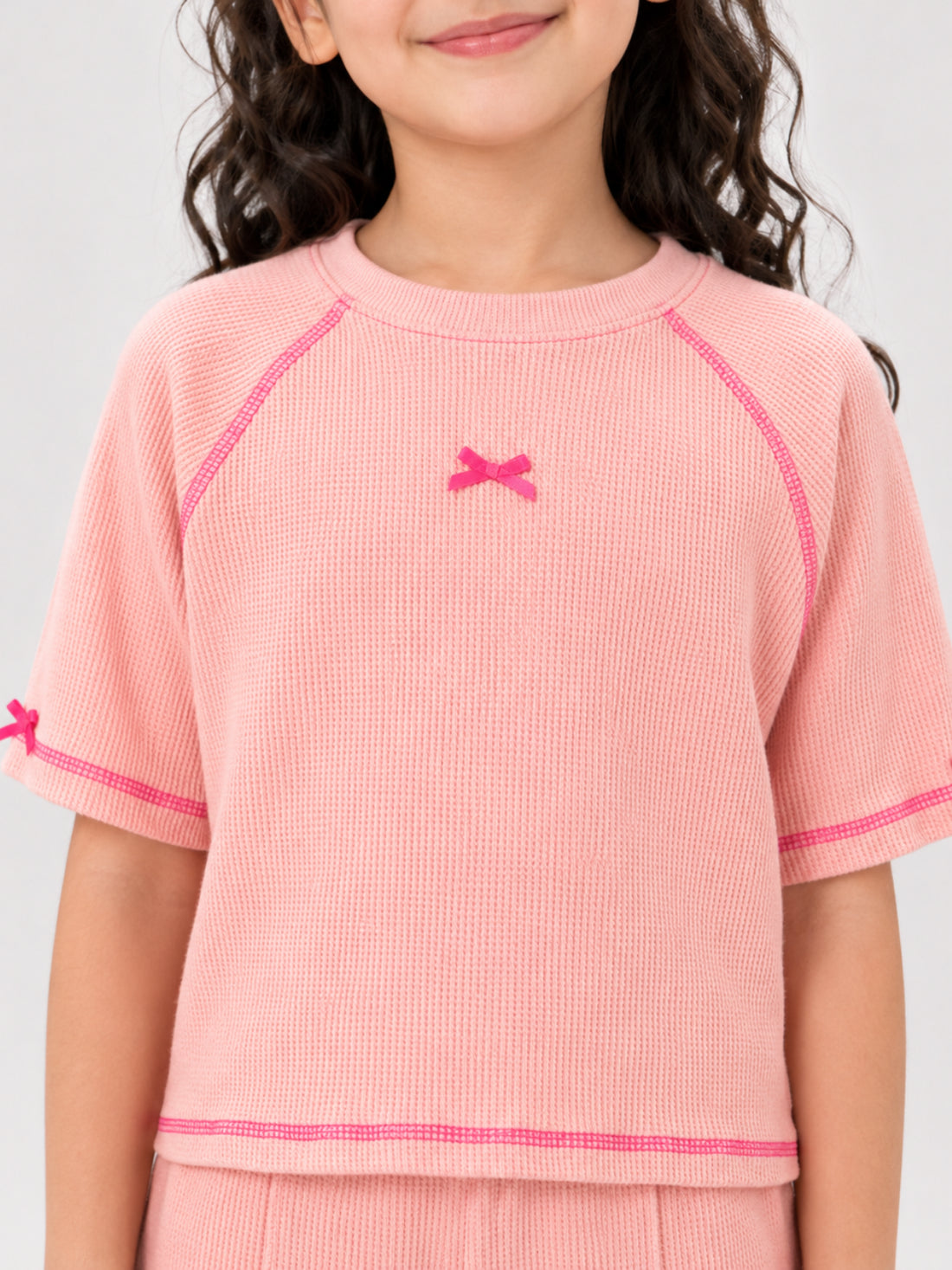 Girls bow-accented waffle co-ord set by Juniors.pk