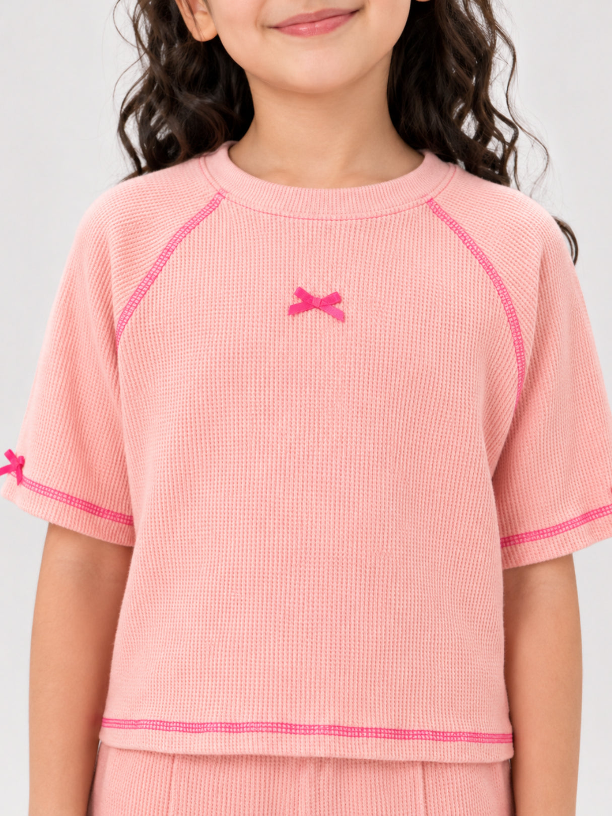 Girls bow-accented waffle co-ord set by Juniors.pk